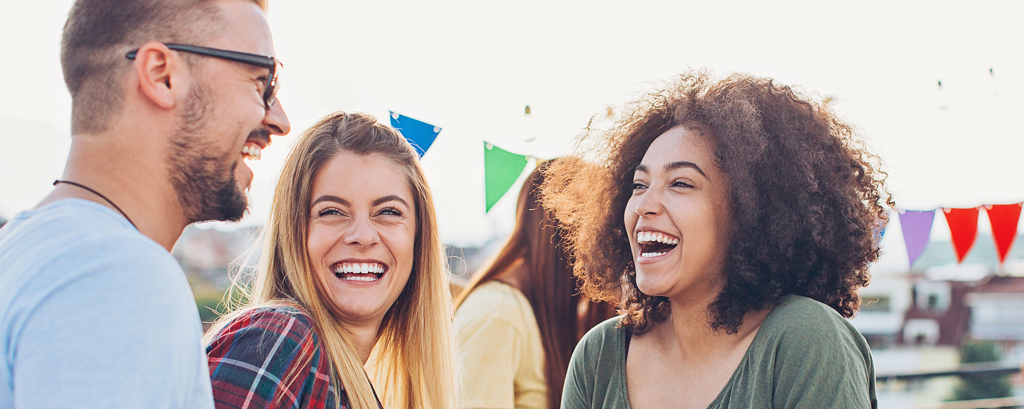 A group of friends huddled together and laughing